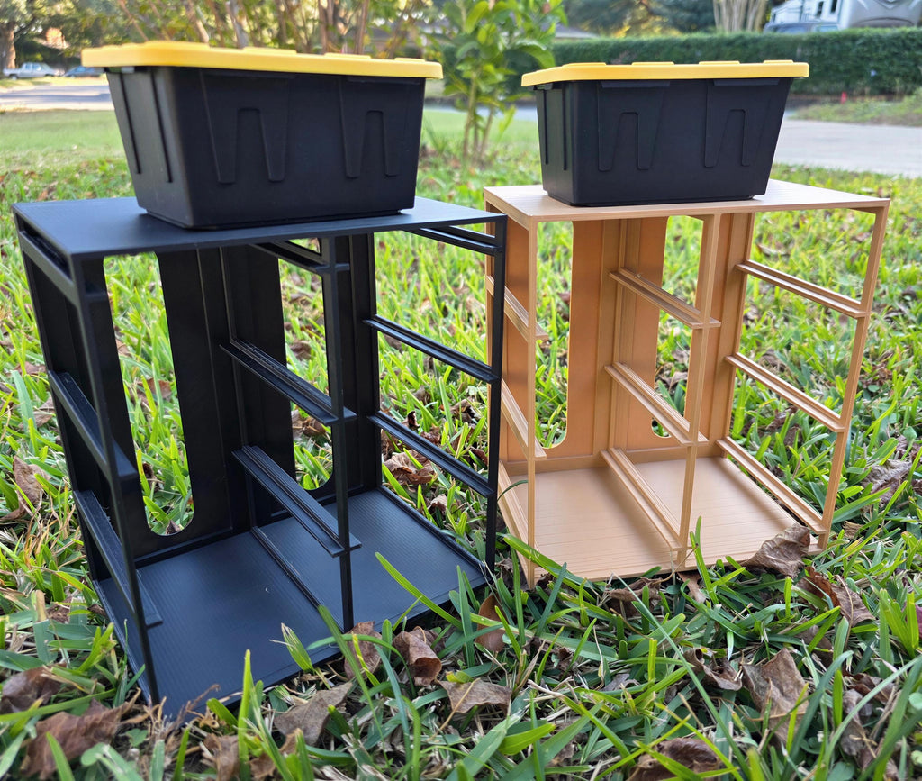 Two storage containers, one black and one brown, are placed on a grassy lawn.
