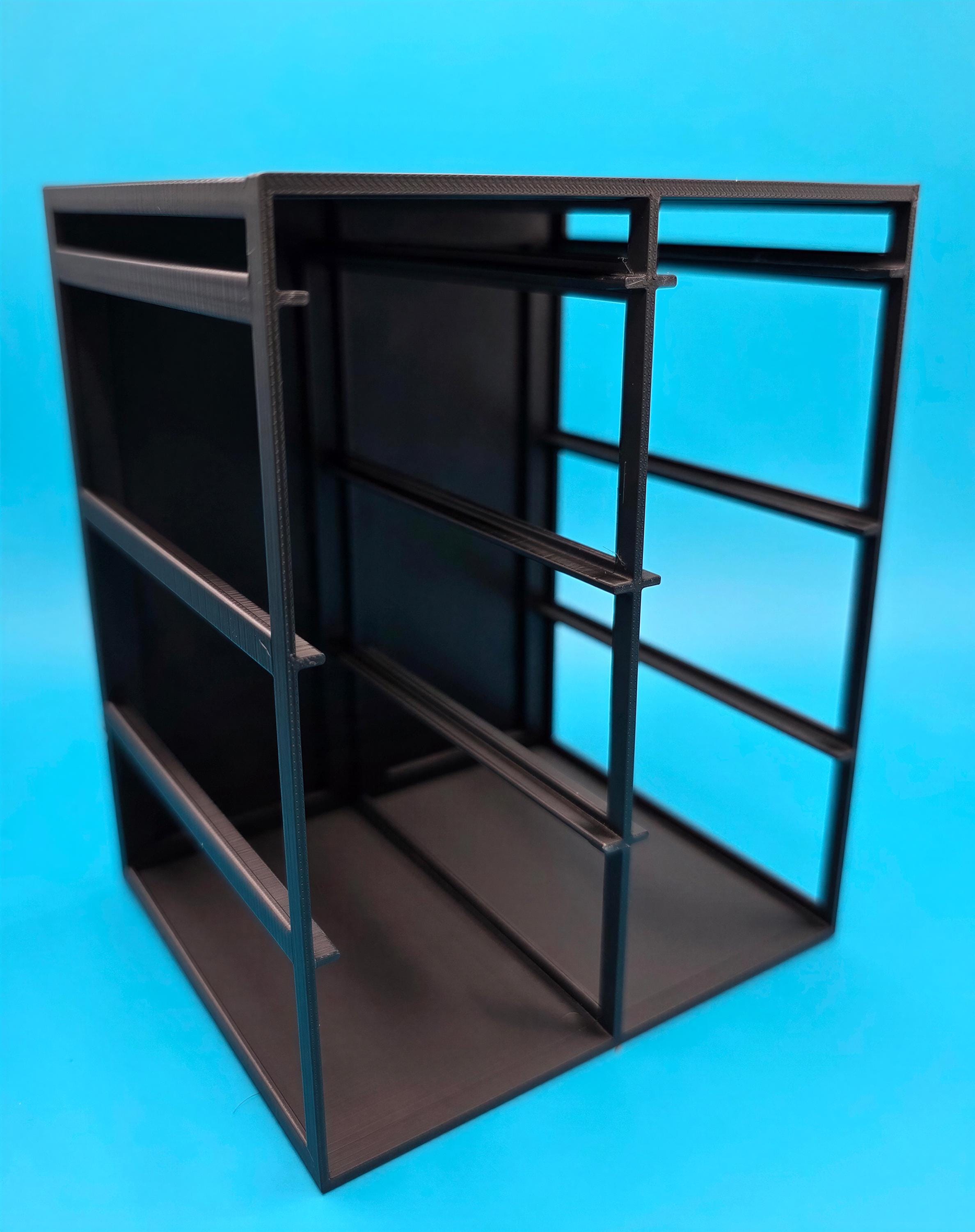 A black metal shelving unit with multiple shelves and compartments, set against a bright blue background.