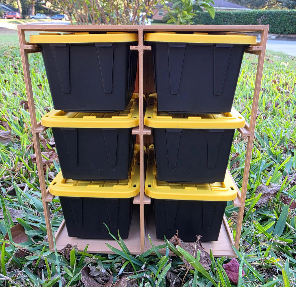 A metal rack holding six black plastic storage bins with yellow lids, placed on a grassy lawn.